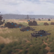 Tanks moving through a field